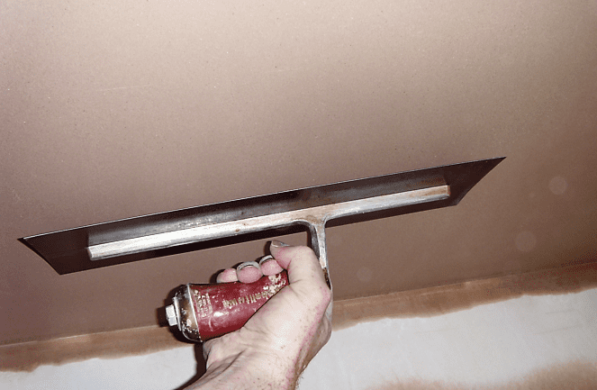 plastering Gloucester - smoothing plaster on ceiling