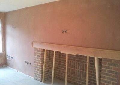 plastering fireplace in building